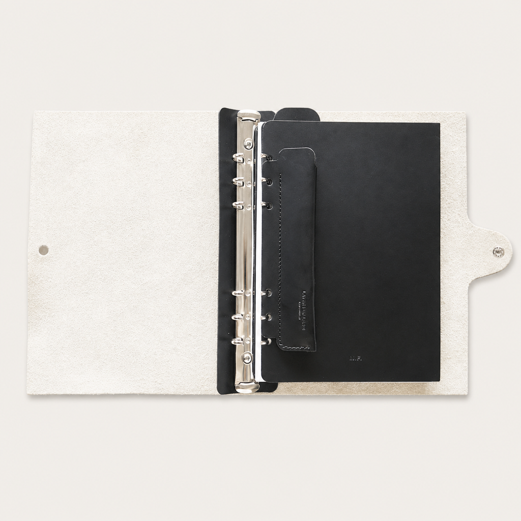 Black leather accessory set installed inside a Layers of LeRoi six-ring journal cover