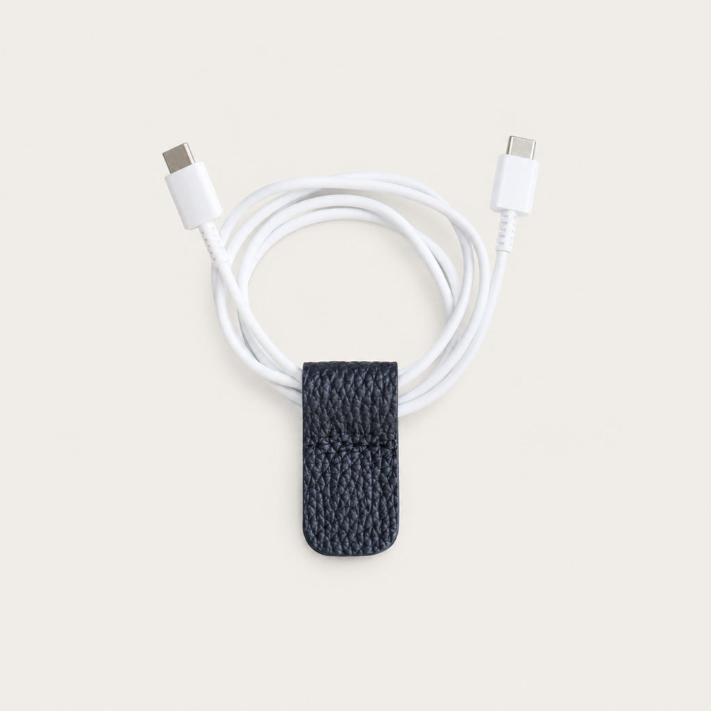 Charging cable secured with a Dark Navy German Togo leather Cord Wrap.