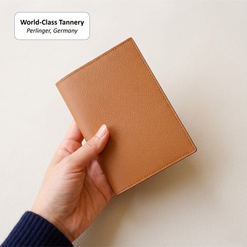 Teak Classic Passport Cover held in one hand for scale
