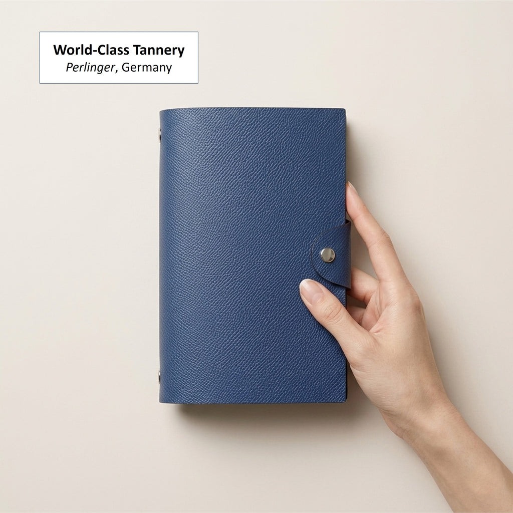 Hand-held Zanzibar Blue German Noblessa leather A6 six-ring journal cover
