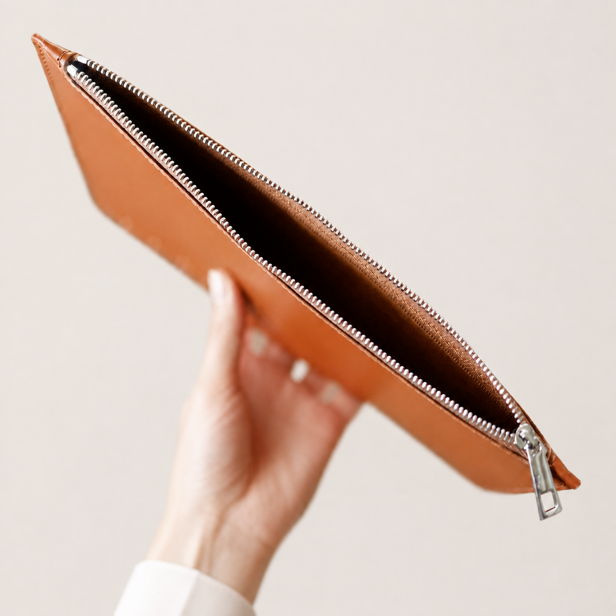 Open Tan leather zip pocket showing the zippered storage compartment
