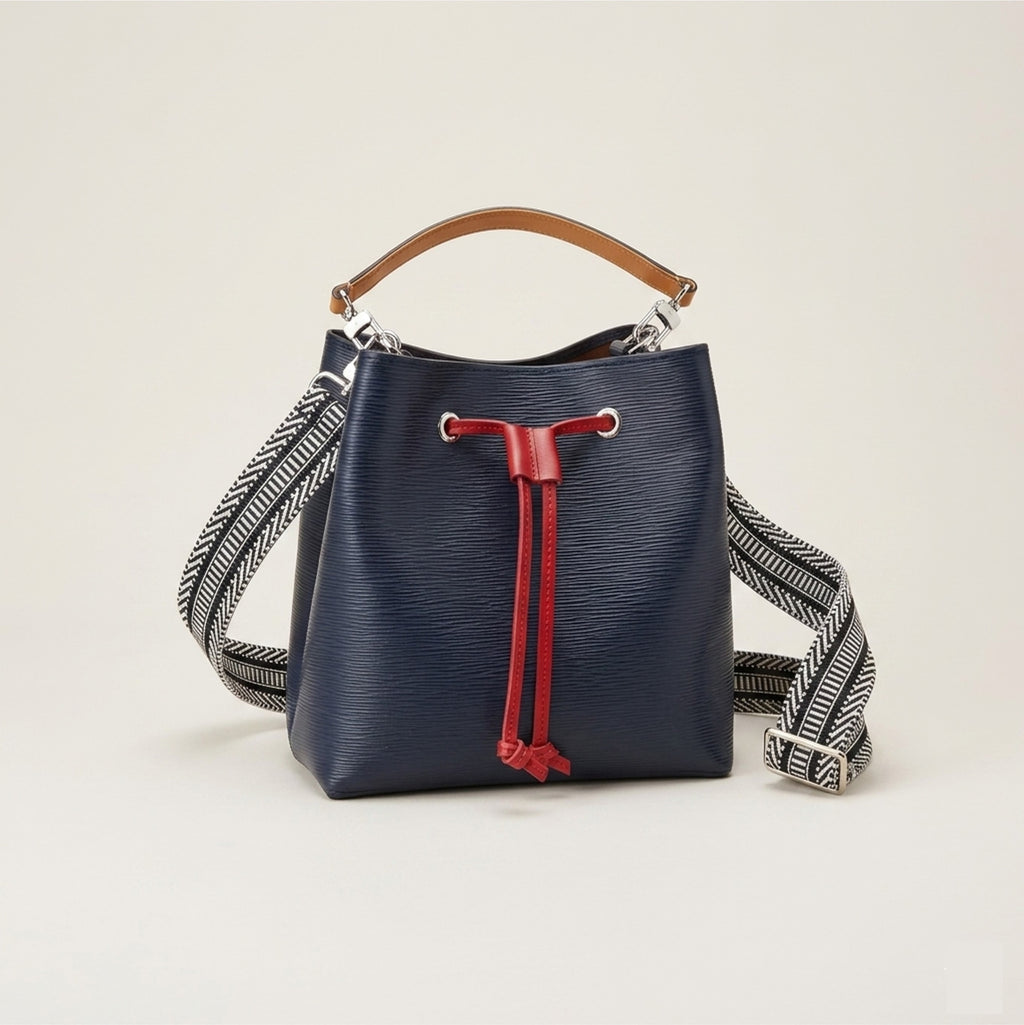 Three-quarter view of the Navy Dorothy Bag with webbing shoulder strap