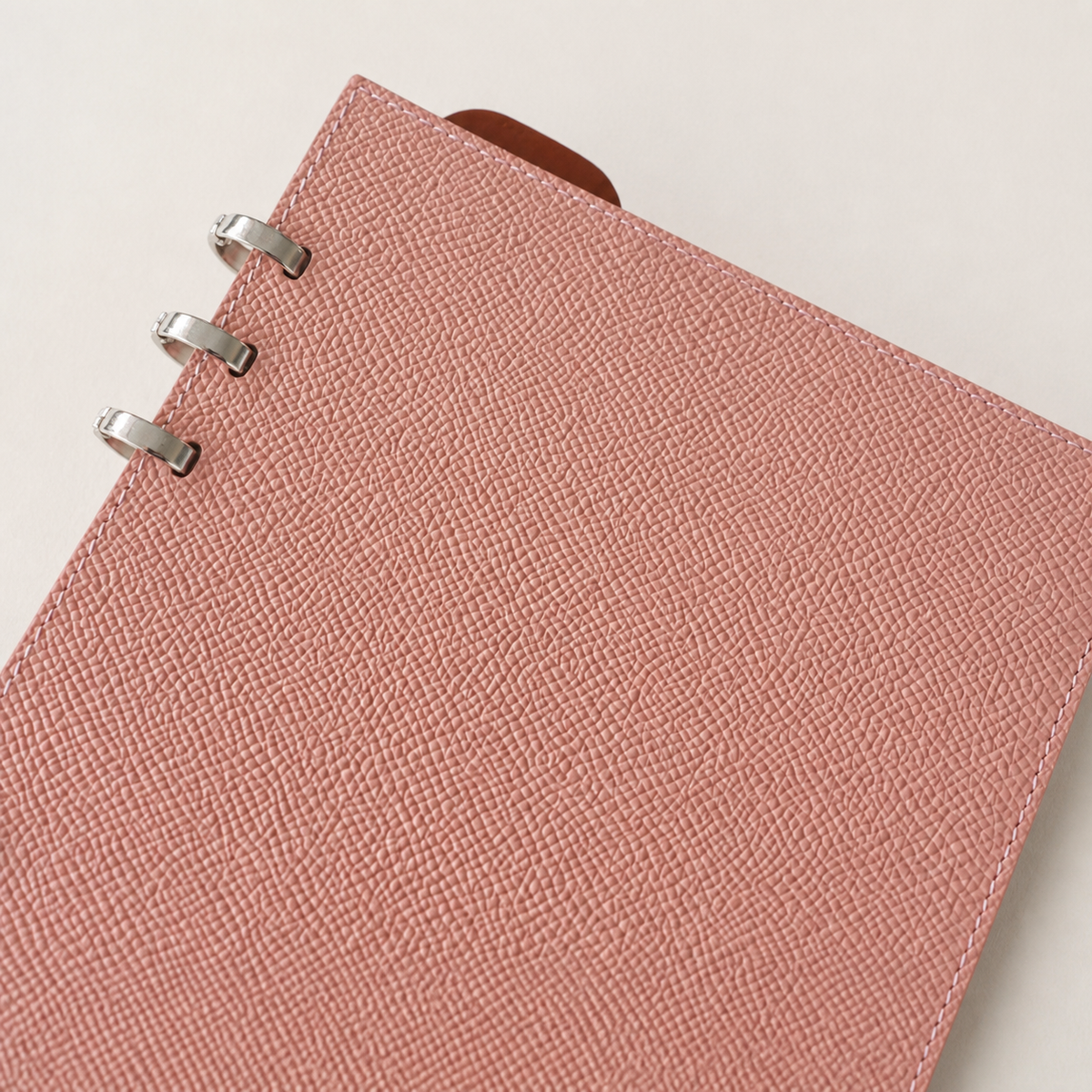 Close-up of the finely grained blush pink Noblessa calfskin binder cover