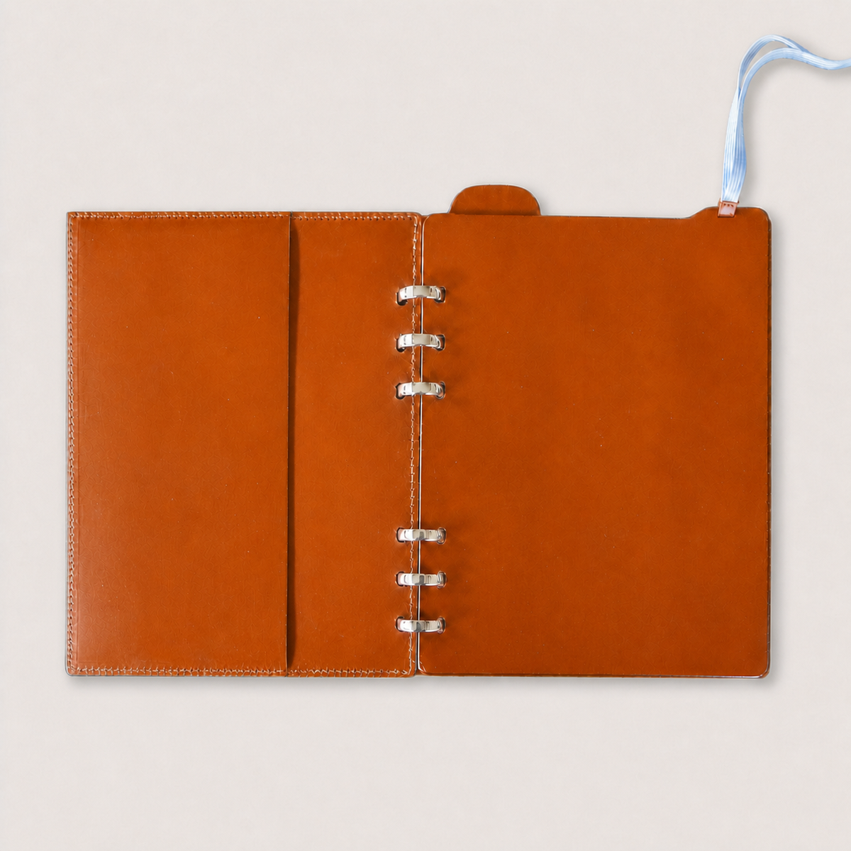Open A5 leather binder showing the fully lined orange Vacchetta interior