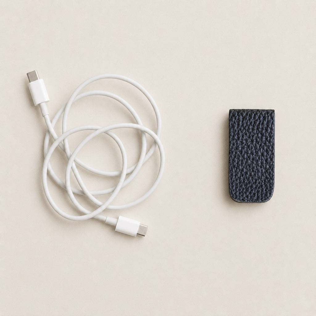 Compact German Togo leather Cord Wrap shown beside a charging cable.