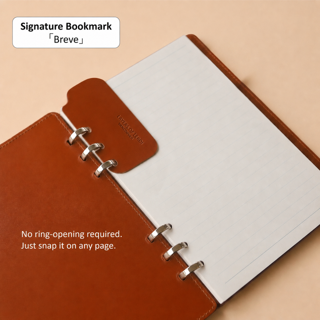 Signature Breve leather bookmark attached to an A5 binder page
