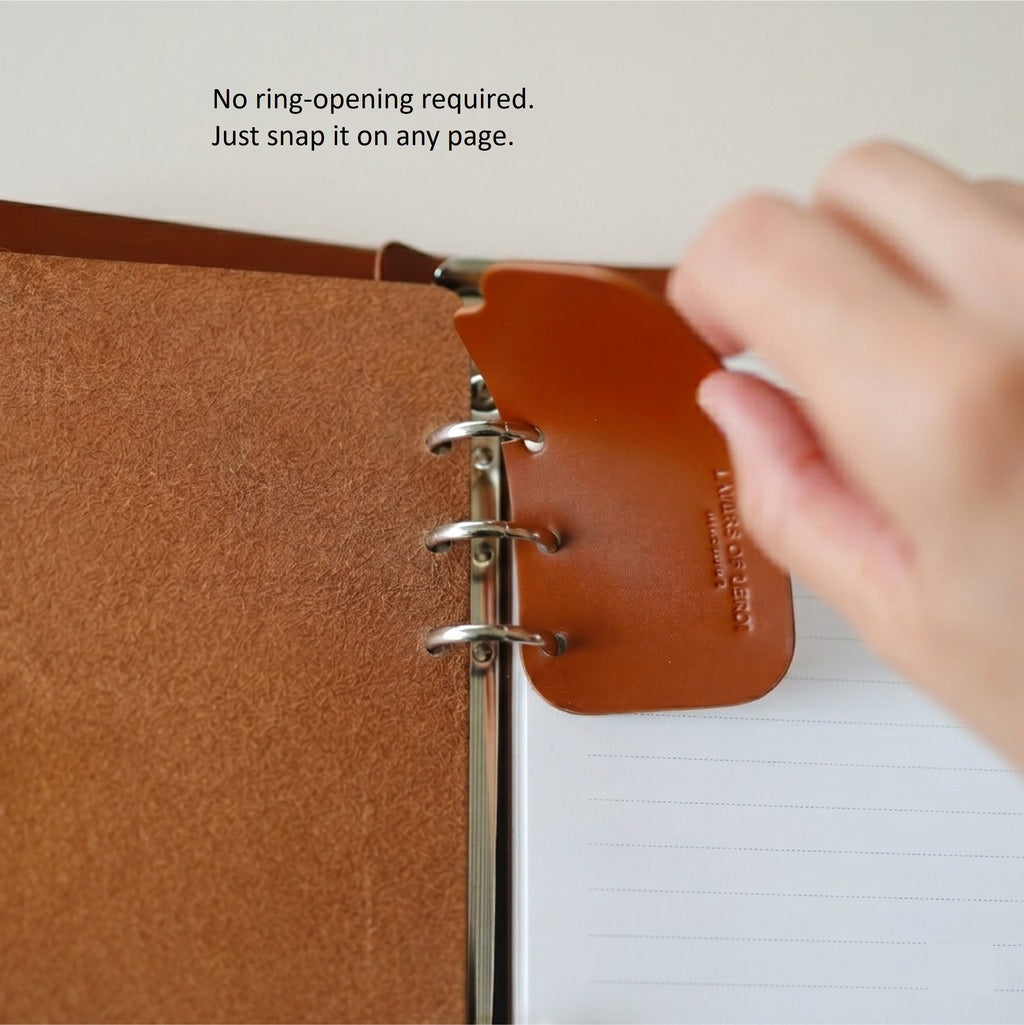 Signature Breve leather bookmark snapping onto A7 ring paper without opening the binder rings