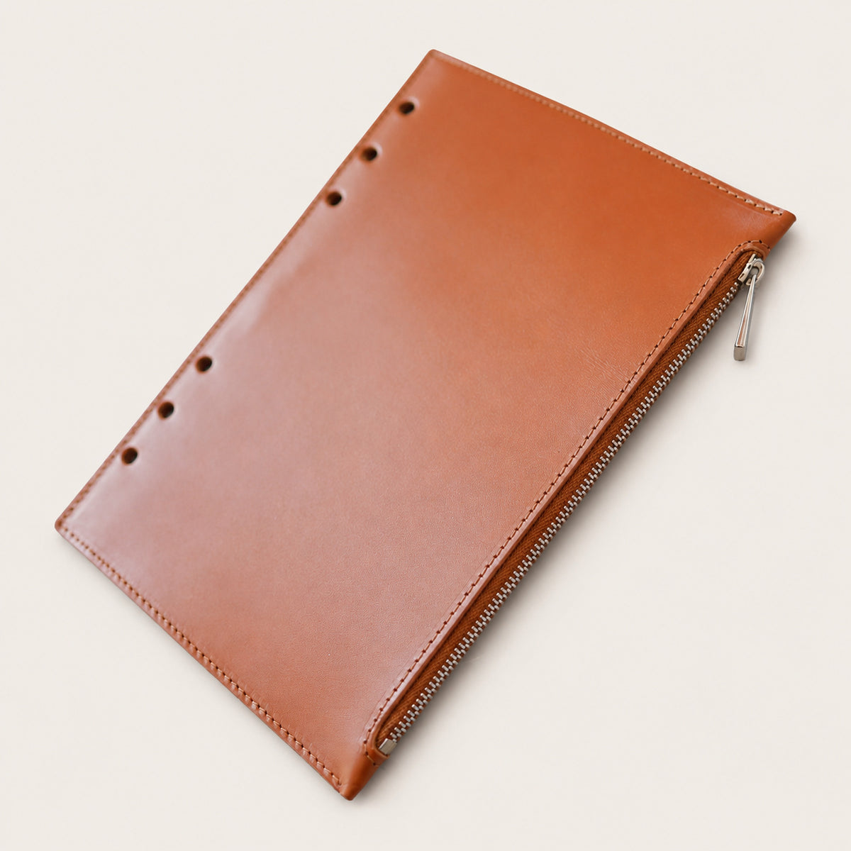 Back view of a Tan detachable leather zip pocket with ring attachment holes
