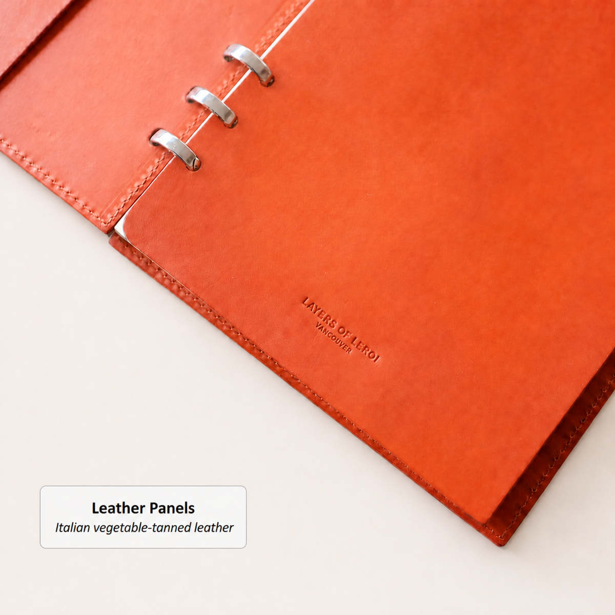 Orange vegetable-tanned Vacchetta leather panels with silver Smart Rings and a debossed logo