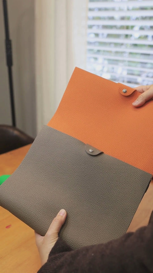 German Togo leather B5 journal covers shown in hand for scale